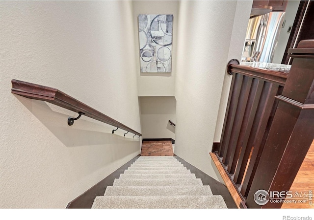 staircase with wood-type flooring