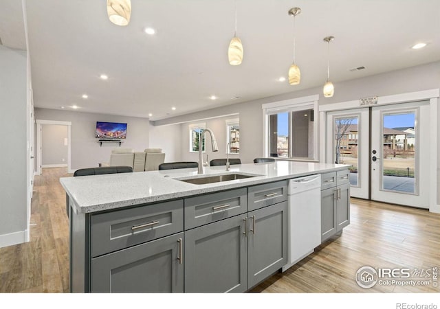 kitchen featuring dishwasher, light hardwood / wood-style flooring, a healthy amount of sunlight, and sink