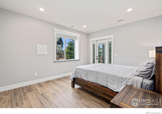 bedroom featuring access to outside and hardwood / wood-style flooring