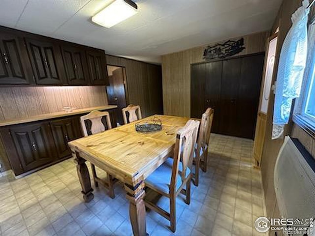 dining room with wooden walls