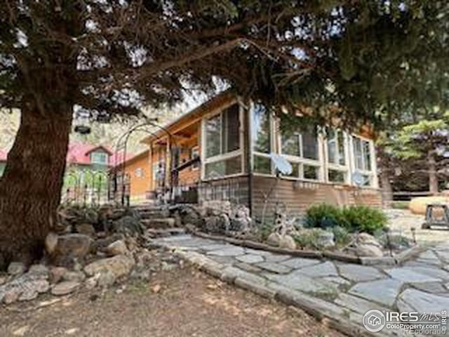 view of side of property featuring a sunroom