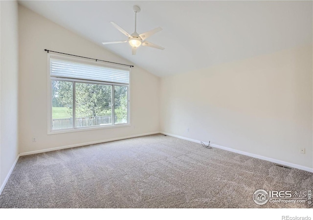 carpeted empty room with vaulted ceiling and ceiling fan