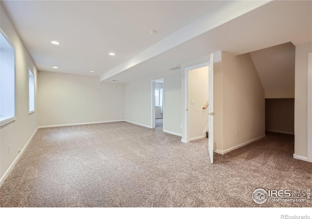 additional living space featuring light colored carpet