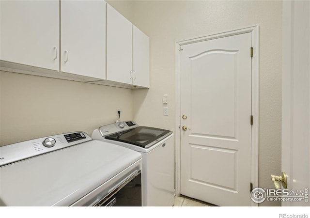 laundry room featuring cabinets and separate washer and dryer