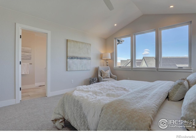 bedroom with ceiling fan, lofted ceiling, light carpet, and ensuite bath