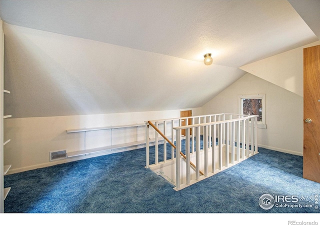 bonus room with carpet and lofted ceiling