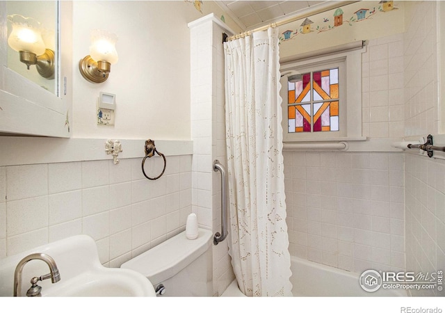 bathroom with toilet, tile walls, and shower / bath combo with shower curtain