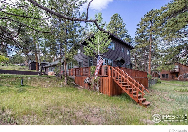 rear view of house with a wooden deck