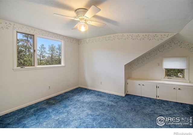 additional living space featuring ceiling fan, carpet, and vaulted ceiling