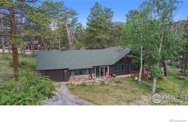 view of front of house with a garage and a front lawn