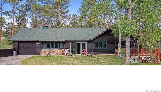 view of front of house with a garage and a front lawn