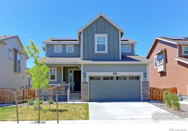 craftsman-style house featuring solar panels, a front yard, and a garage