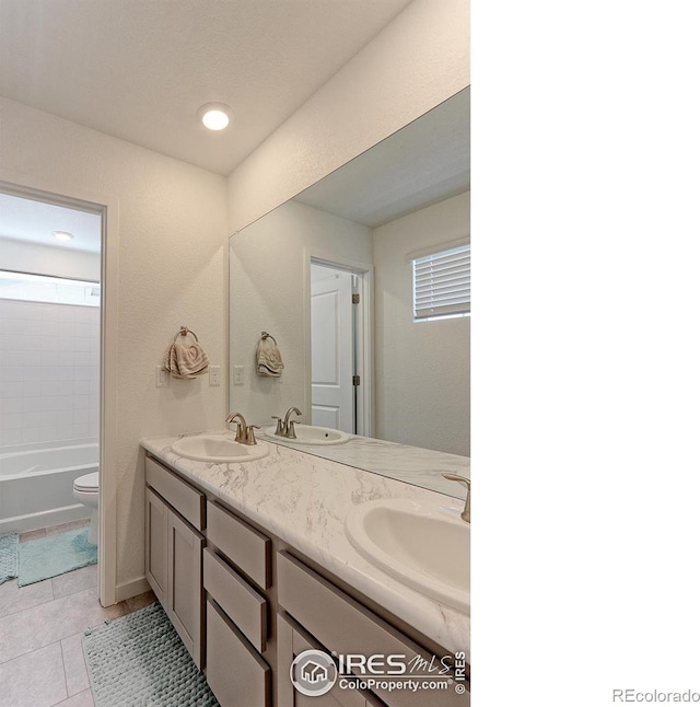 bathroom featuring tile patterned floors, vanity, and toilet