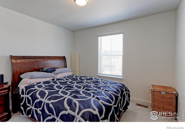 bedroom featuring light carpet