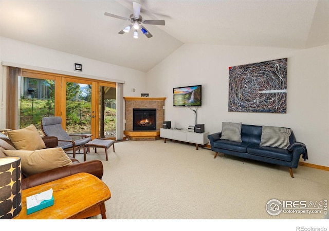 carpeted living room featuring a tile fireplace, ceiling fan, lofted ceiling, and baseboards