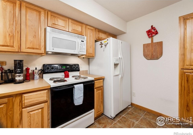 kitchen with light countertops, white appliances, and baseboards