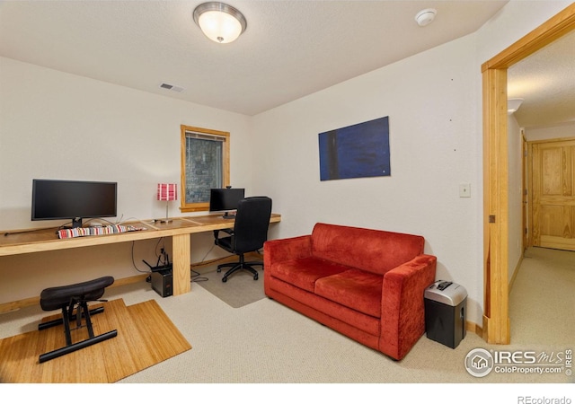 office space featuring carpet flooring, visible vents, and baseboards