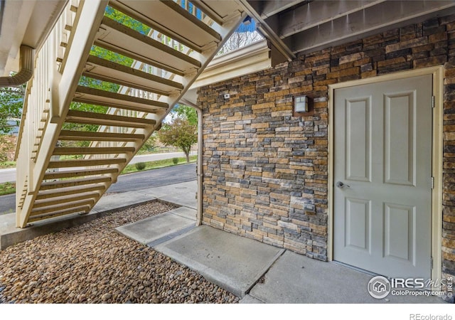 property entrance featuring stone siding