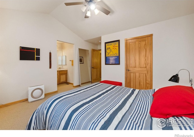 bedroom featuring carpet floors, ensuite bathroom, vaulted ceiling, ceiling fan, and baseboards