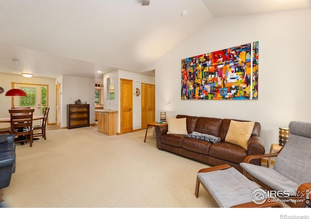 living area featuring lofted ceiling and light colored carpet