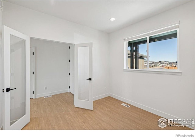 unfurnished room with light wood-type flooring