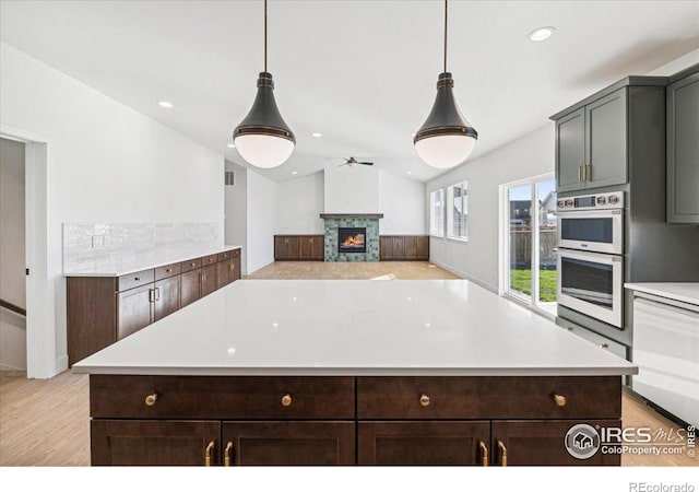 kitchen featuring light hardwood / wood-style flooring, a center island, and hanging light fixtures