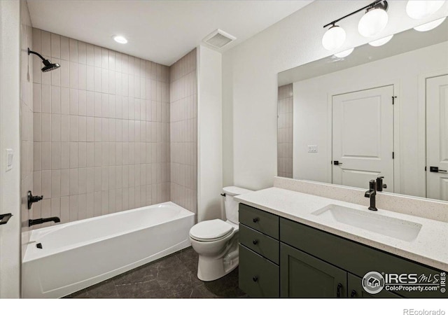 full bathroom with tile patterned floors, toilet, vanity, and tiled shower / bath