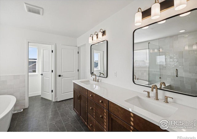 bathroom featuring separate shower and tub, tile patterned floors, plenty of natural light, and vanity