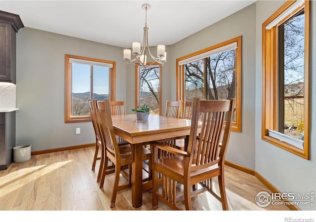 dining space with a chandelier and light hardwood / wood-style floors