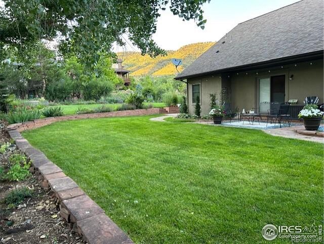 view of yard featuring a mountain view and a patio area