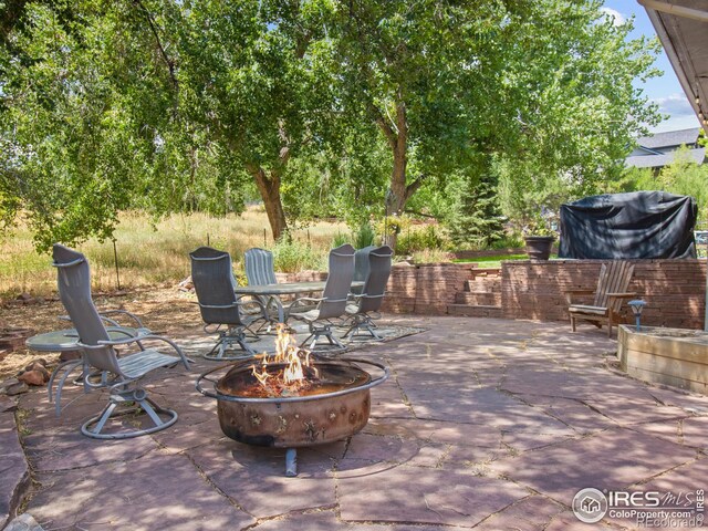 view of patio / terrace featuring an outdoor fire pit