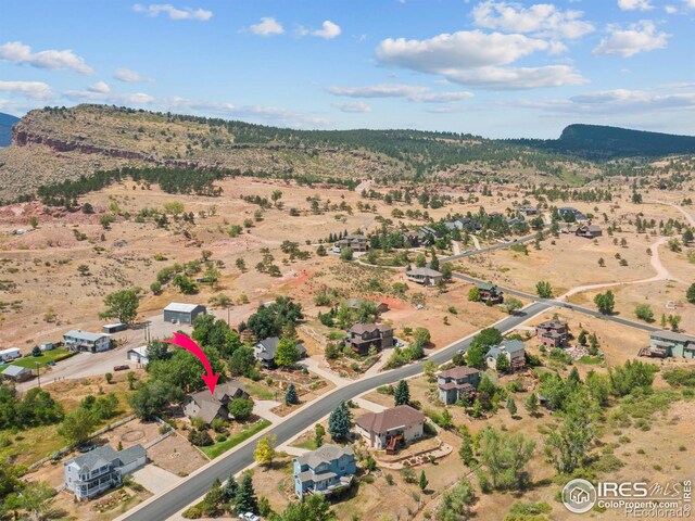 birds eye view of property featuring a mountain view