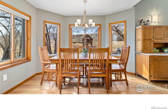 dining space featuring a notable chandelier and light hardwood / wood-style flooring