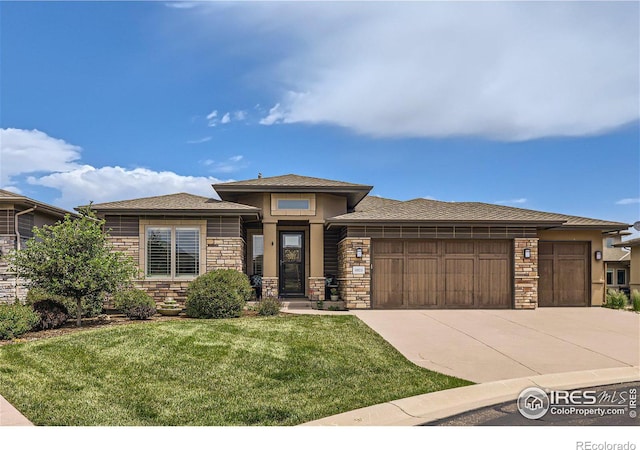 prairie-style house with a front yard and a garage