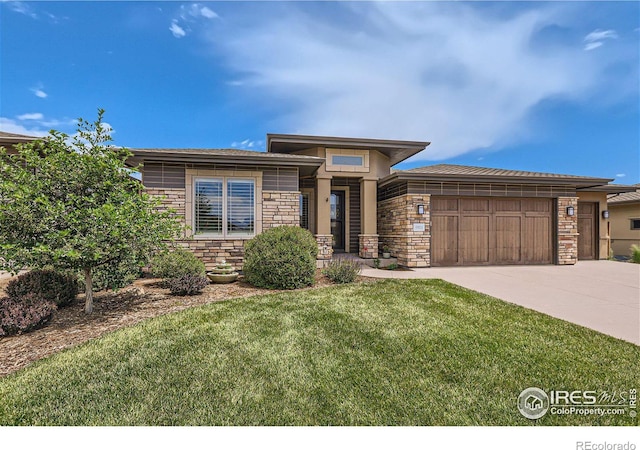 prairie-style house with a front yard and a garage