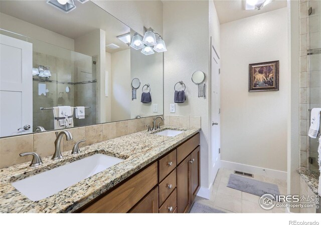 bathroom with tile patterned floors, vanity, and walk in shower