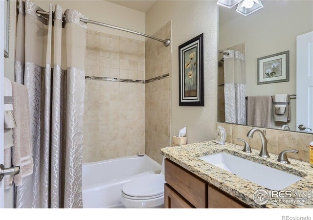 full bathroom featuring vanity, toilet, and shower / tub combo