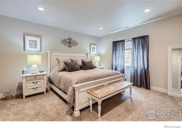 bedroom featuring light colored carpet