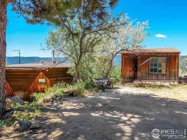 view of property exterior with a mountain view