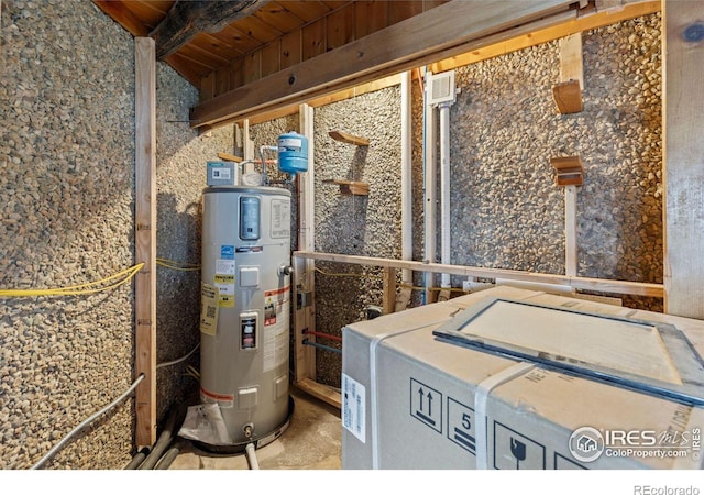 utility room featuring water heater