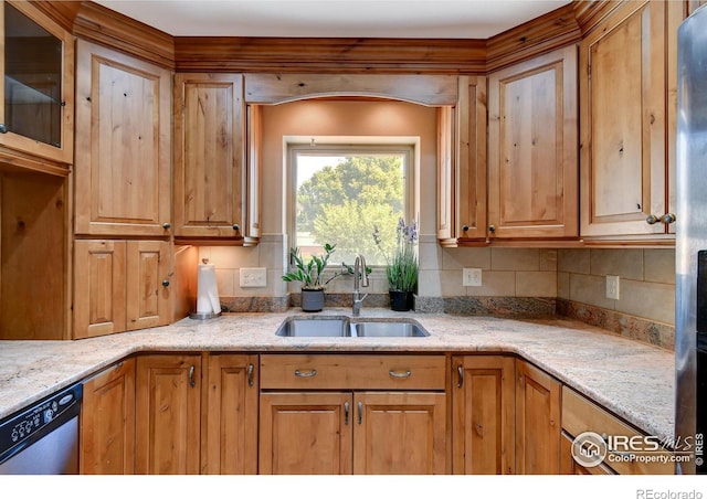 kitchen with decorative backsplash, light stone countertops, sink, and stainless steel dishwasher