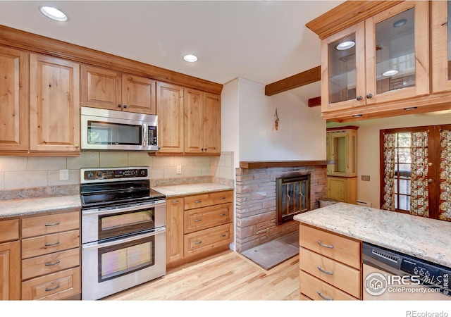 kitchen featuring light hardwood / wood-style flooring, decorative backsplash, light stone countertops, beam ceiling, and stainless steel appliances