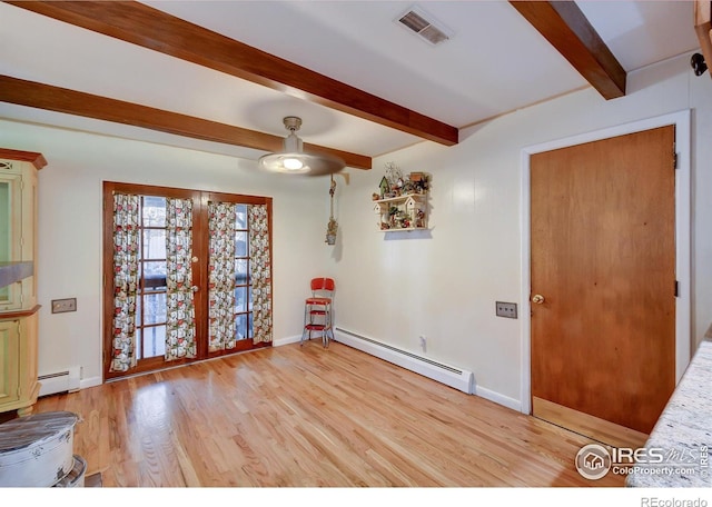 unfurnished room with beamed ceiling, light hardwood / wood-style floors, french doors, and a baseboard radiator