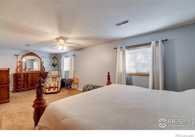 carpeted bedroom with ceiling fan and a baseboard radiator