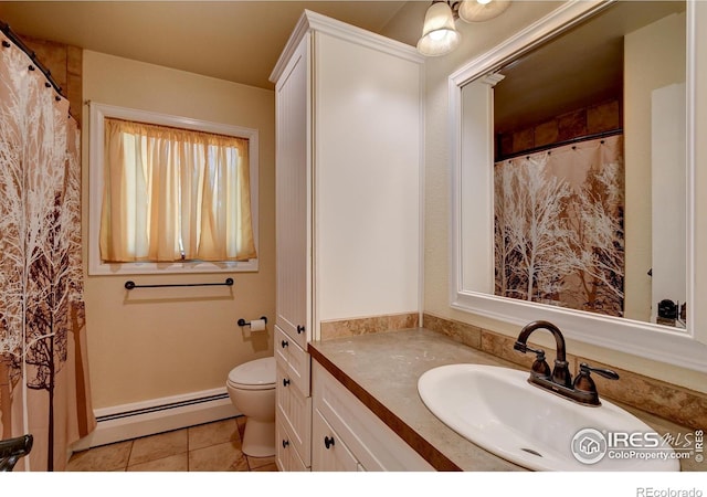 bathroom with tile patterned flooring, vanity, toilet, and a baseboard heating unit