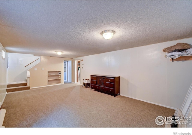 interior space featuring built in shelves and a textured ceiling