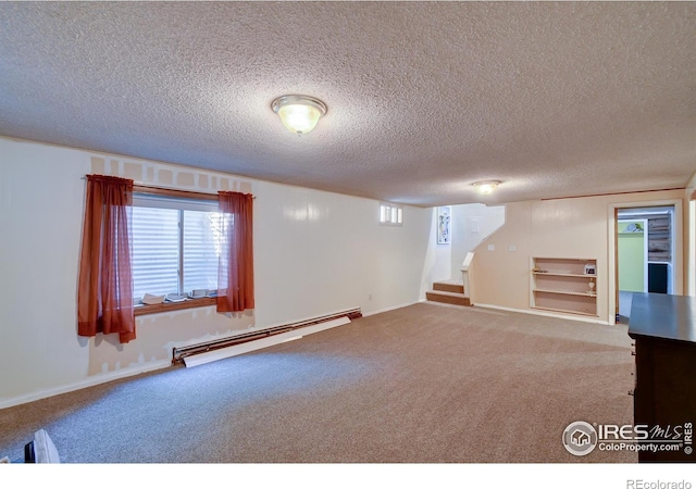 basement featuring carpet, a textured ceiling, a baseboard radiator, and built in features