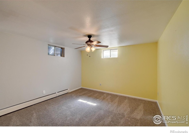 empty room with carpet floors, a baseboard radiator, and a textured ceiling