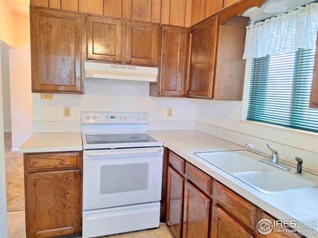 kitchen featuring sink and white electric range oven