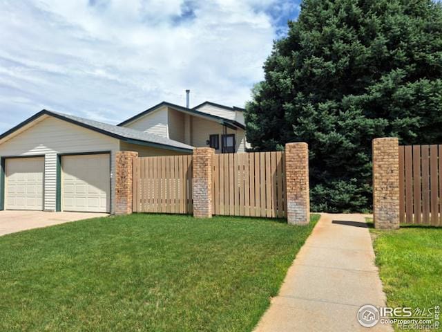 view of front of house with a garage and a front lawn